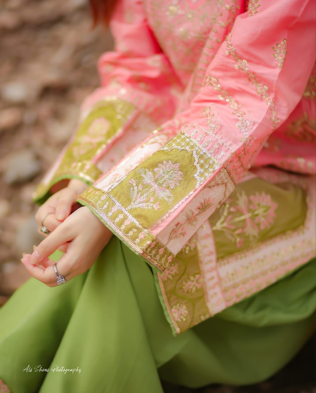 Close-up of pink and green embroidered Pakistani suit detailing