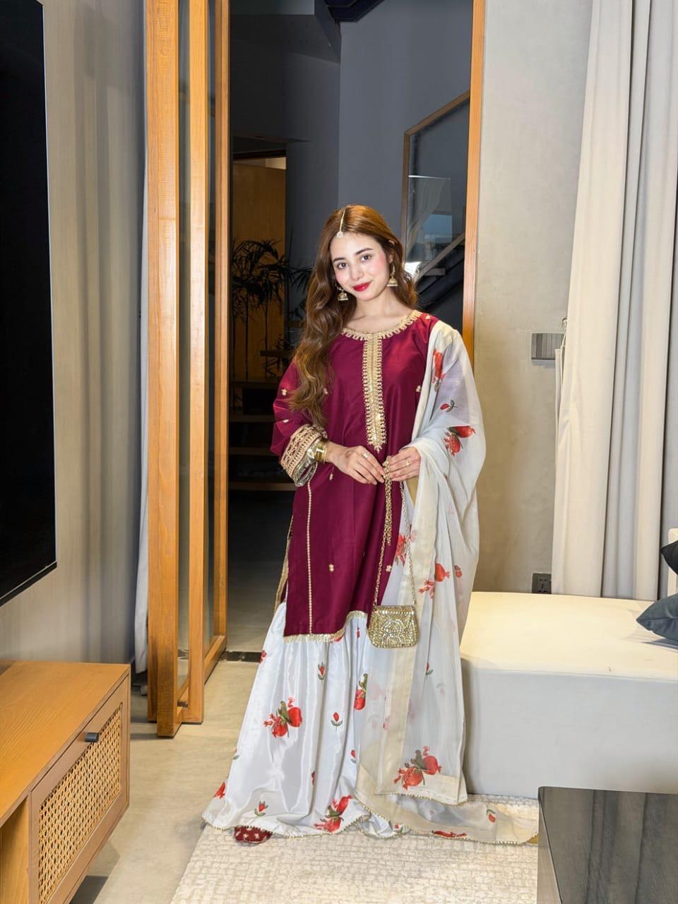 Maroon women's ethnic dress with golden embroidery and floral dupatta